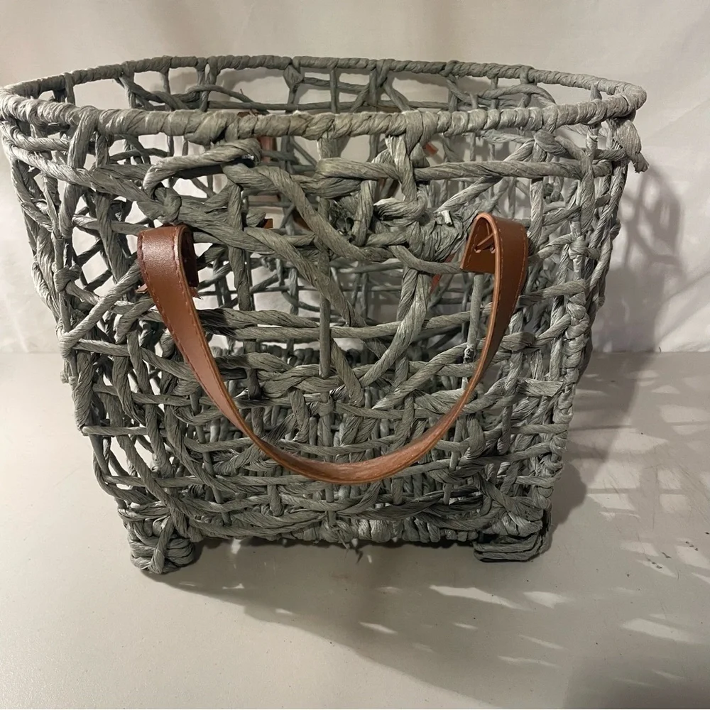 Woven gray Basket with brown Leather Handles width 14” deep 11” 4 metal feet